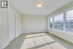 Spare room featuring light carpet - 