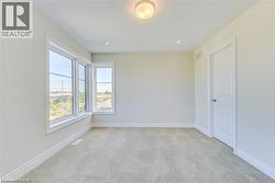 Empty room with light carpet and recessed lighting - 