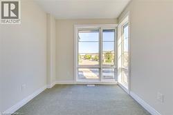 Unfurnished room with light colored carpet and baseboards - 