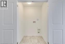 Laundry room featuring hookup for a washing machine and baseboards - 