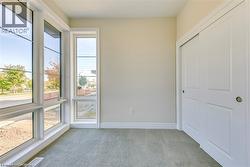 Unfurnished bedroom featuring light colored carpet and a closet - 