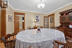 Dining room featuring crown molding and a textured ceiling - 