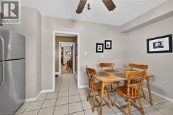 Dining area with a ceiling fan and light tile patterned floors - 