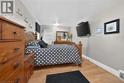 Bedroom featuring baseboards and light wood-type flooring - 