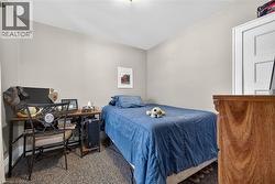 Carpeted bedroom featuring baseboards - 