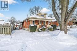 Bungalow with covered porch and brick siding - 