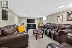 Carpeted living room featuring wooden walls - 