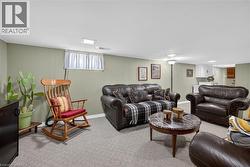 Carpeted living room featuring wooden walls - 