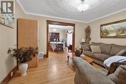 Living room featuring crown molding and hardwood / wood-style flooring - 