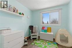 Rec room with wood finished floors and a textured ceiling - 