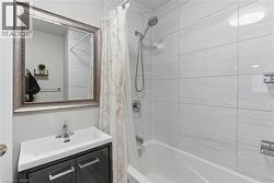 Bathroom with shower / bath combo with shower curtain and vanity - 