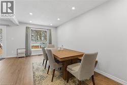 Dining space with recessed lighting, light wood finished floors, and a textured ceiling - 