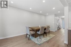 Dining room with recessed lighting and light wood-style floors - 