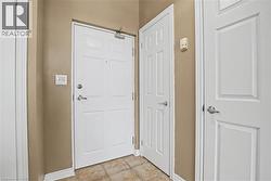 Entryway with light tile patterned floors - 