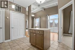Kitchen featuring, light countertops, wood ceiling, french doors, and light tile patterned floors - 