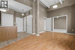 Foyer featuring high vaulted ceiling, light natural coloured floors, and a wooden ceiling with exposed beams - 
