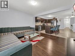 Living room with dark wood-style flooring and a textured ceiling - 