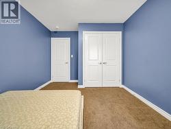 Unfurnished bedroom with carpet floors and a closet - 