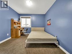 Bedroom with carpet floors and a textured ceiling - 