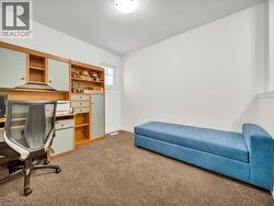 Office space featuring light colored carpet and a textured ceiling - 
