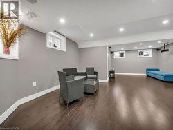 Living area featuring dark wood-style floors and recessed lighting - 