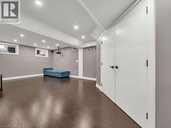 Unfurnished room featuring recessed lighting and dark wood-style floors - 