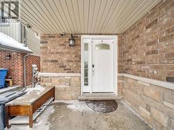 View of exterior entry with brick siding and stone siding - 