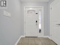 Entryway with baseboards and light tile patterned floors - 
