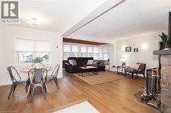Dining area with light wood-style flooring and a stone fireplace - 