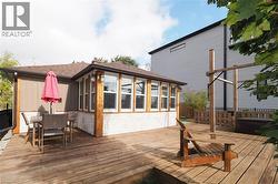 Deck with a sunroom and outdoor dining area - 