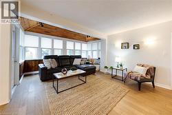 Living area with light wood-type flooring and wooden ceiling - 