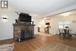Living room with wood finished floors and a fireplace - 