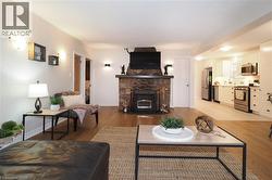 Living room featuring a fireplace and light wood finished floors - 