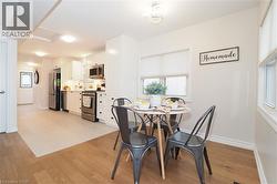Dining space with light wood-style flooring and baseboards - 