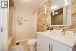 Full bathroom featuring vanity and combined bath / shower with glass door - 