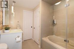 Bathroom with vanity and tiled shower / bath - 