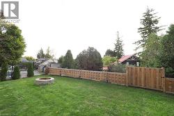 Fenced backyard featuring a fire pit - 