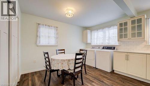 Dining area with dark wood-style floors, washer and clothes dryer, and beam ceiling - 14 Grandview Street, Brantford, ON - Indoor Photo Showing Laundry Room
