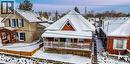 Snow covered rear of property featuring a residential view, a wooden deck, and brick siding - 14 Grandview Street, Brantford, ON  - Outdoor 