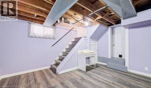 Unfinished below grade area featuring wood finished floors and stairway - 14 Grandview Street, Brantford, ON - Indoor