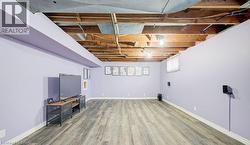 Below grade area featuring light wood-type flooring and baseboards - 