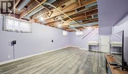 Below grade area with light wood-type flooring and baseboards - 