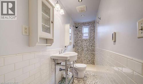 Bathroom with wainscoting, tile walls, tiled shower, tile patterned flooring, and recessed lighting - 14 Grandview Street, Brantford, ON - Indoor Photo Showing Bathroom