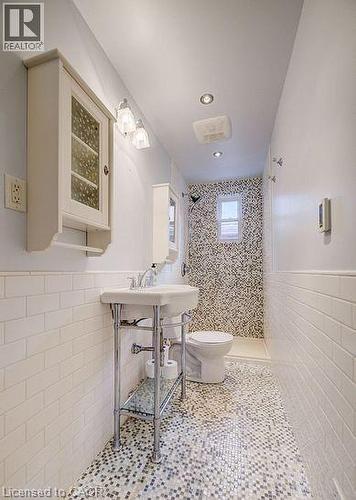 Bathroom with tile walls, wainscoting, tiled shower, recessed lighting, and tile patterned flooring - 14 Grandview Street, Brantford, ON - Indoor Photo Showing Bathroom