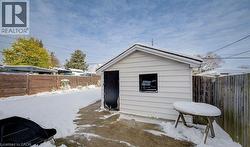 Snow covered structure with a fenced backyard - 