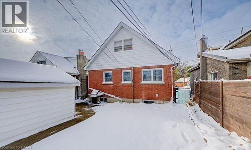 Snow covered rear of property featuring brick siding - 14 Grandview Street, Brantford, ON - Outdoor With Exterior