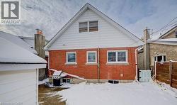 Snow covered property with brick siding - 
