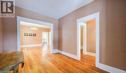 Corridor featuring a chandelier and light wood finished floors - 