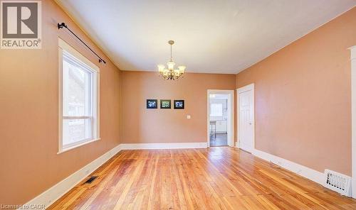 Spare room with a chandelier and light wood finished floors - 14 Grandview Street, Brantford, ON - Indoor Photo Showing Other Room