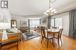 Beautiful dining area with sliding patio doors leading to your balcony, offering a lovely view in every season. - 